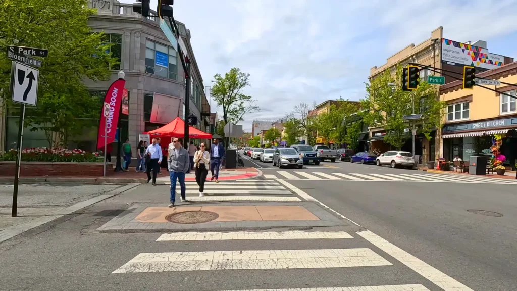 Pedestrians crossing the street in downtown Montclair NJ, a top commuter town near NYC. Downtown Montclair NJ Street View